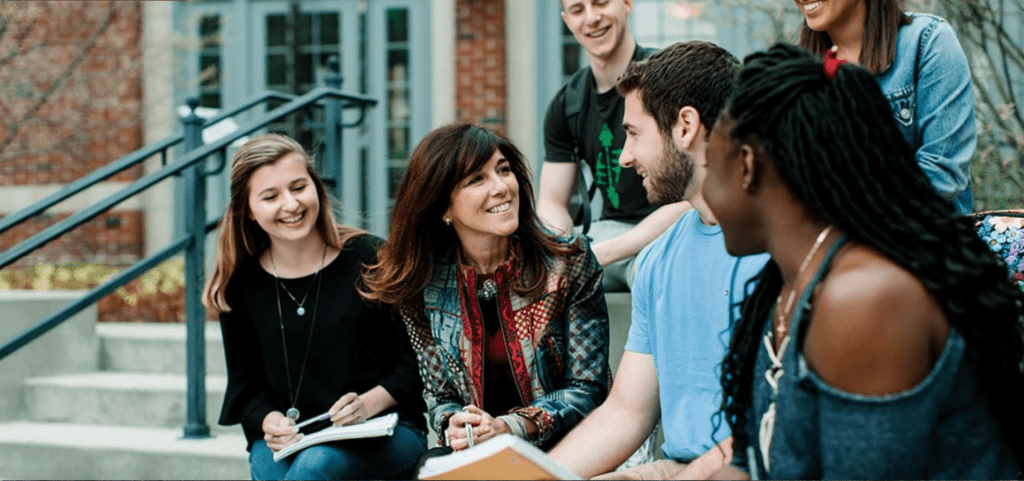 students chatting with a professor